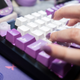 A photo of fingers typing on a Keychron Q3